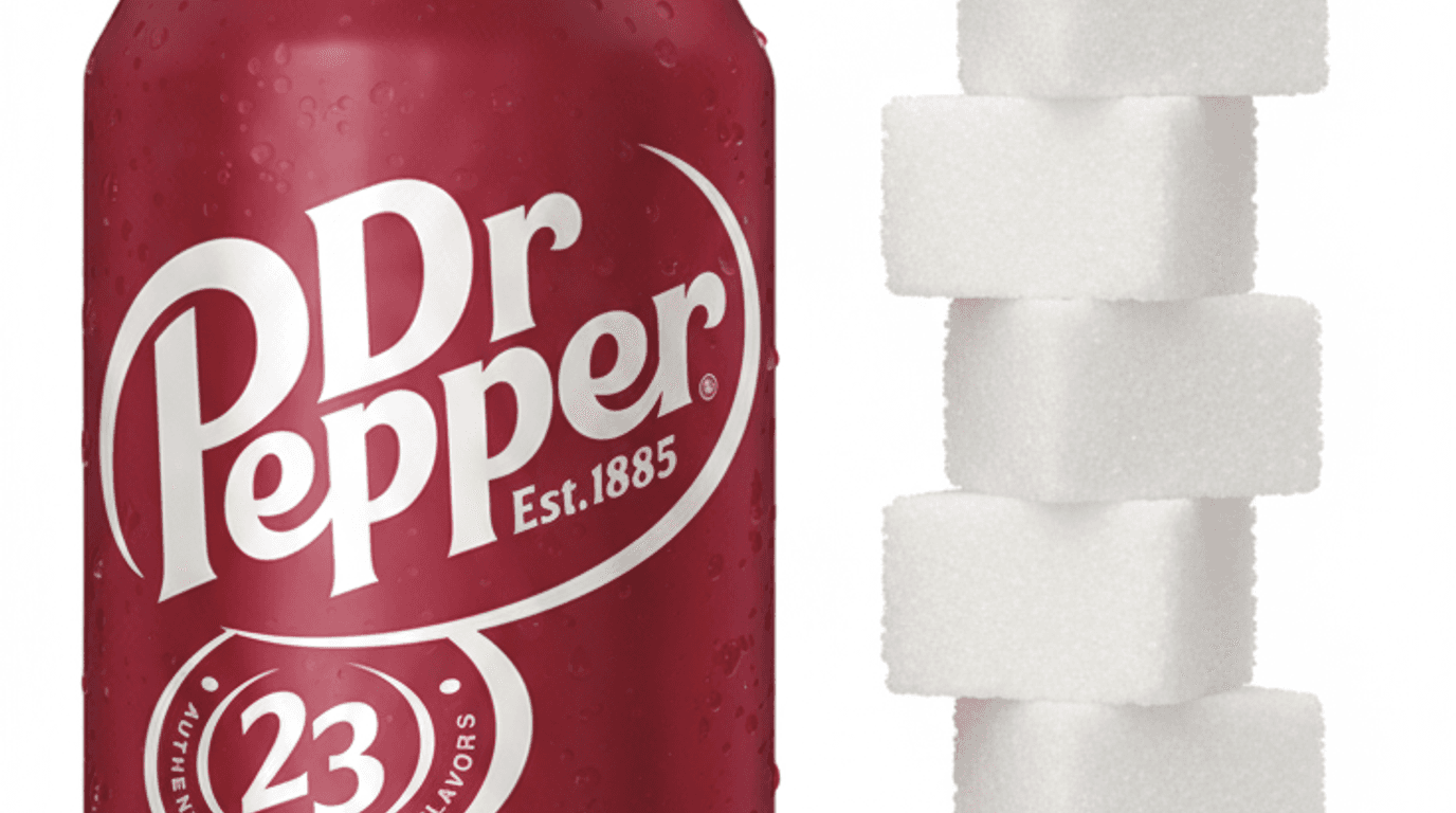 A 12 oz can of Dr Pepper next to a small pile of sugar representing its 40 grams of added sugar