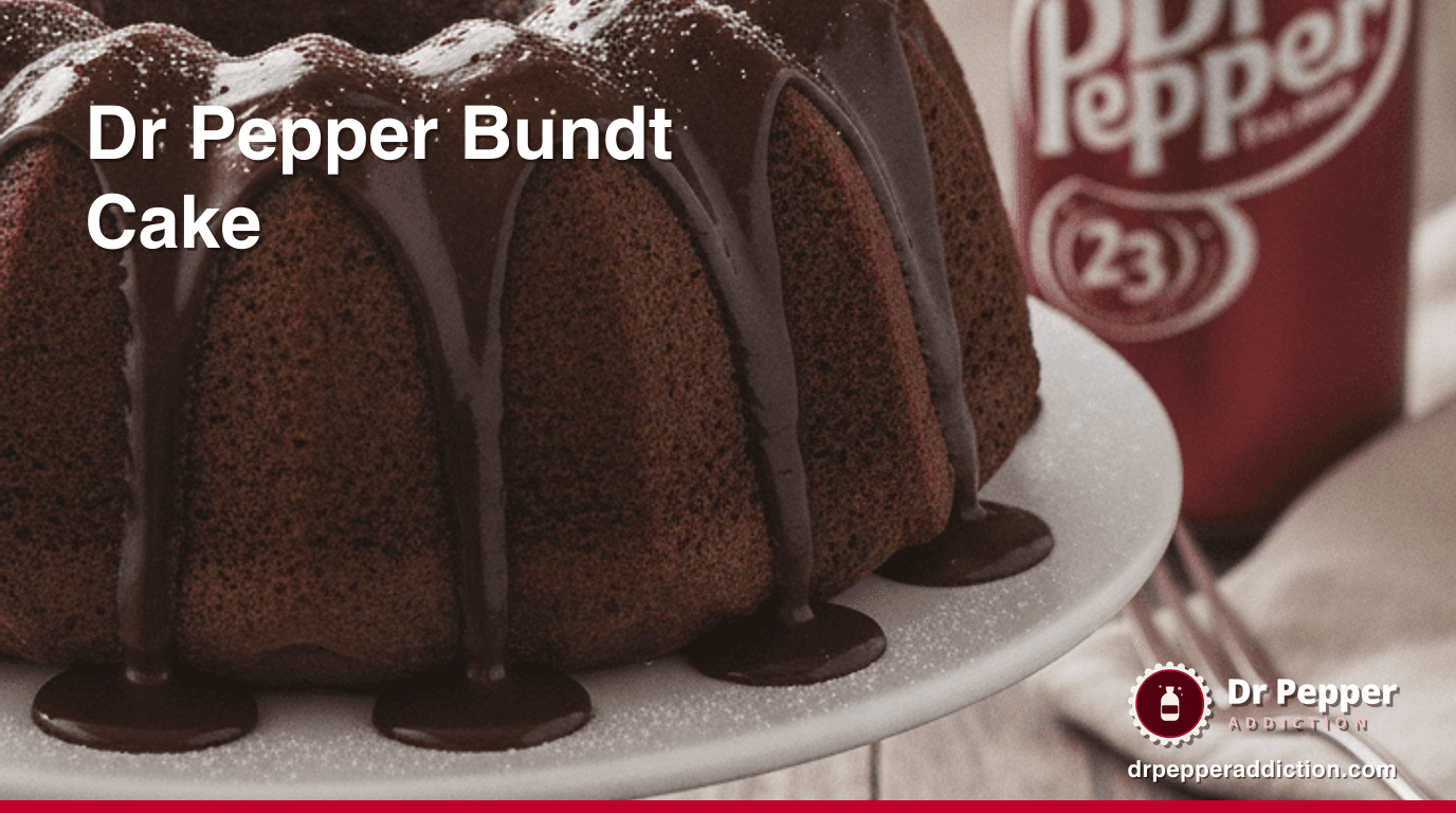 A Dr Pepper chocolate bundt cake with glossy glaze dripping down the ridges, a can of Dr Pepper beside it