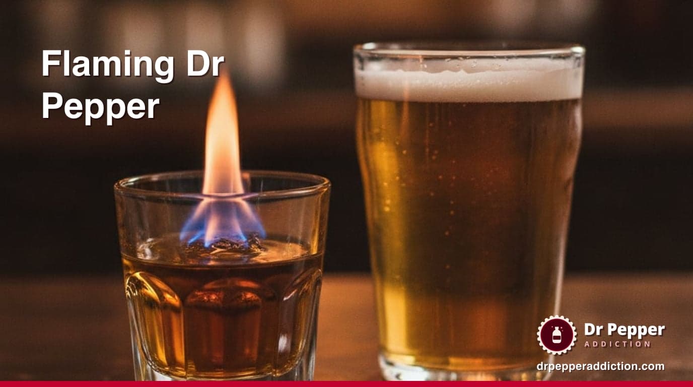 A shot glass with a small blue flame above it beside a half-filled glass of amber beer on a dark bar top