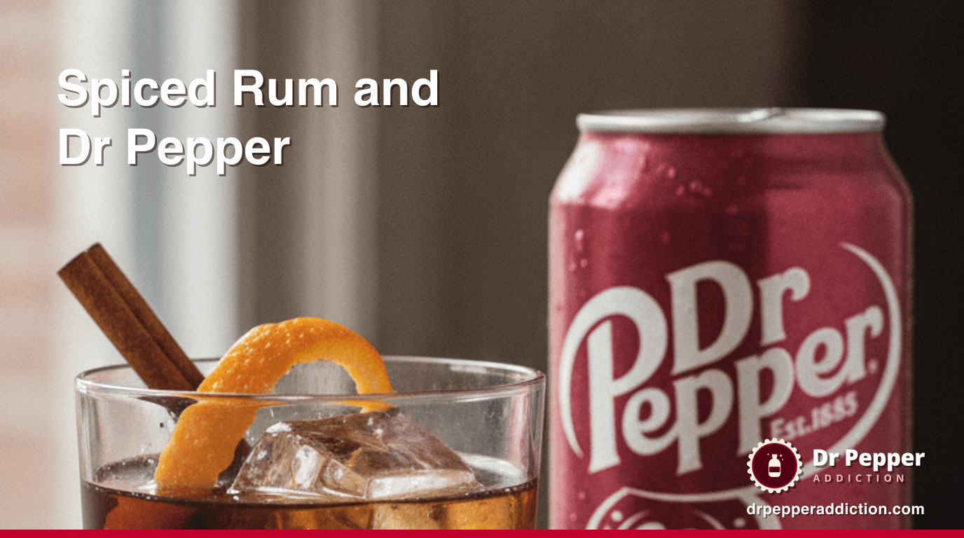 A rocks glass of spiced rum and Dr Pepper over a large ice cube with a cinnamon stick, a can of Dr Pepper beside it