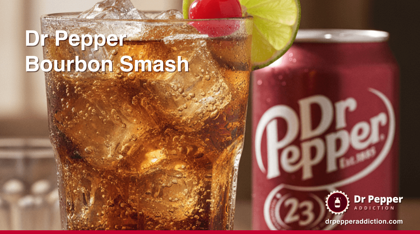 A tall Dr Pepper bourbon smash over ice with a lime wheel and cherry, a can of Dr Pepper beside it