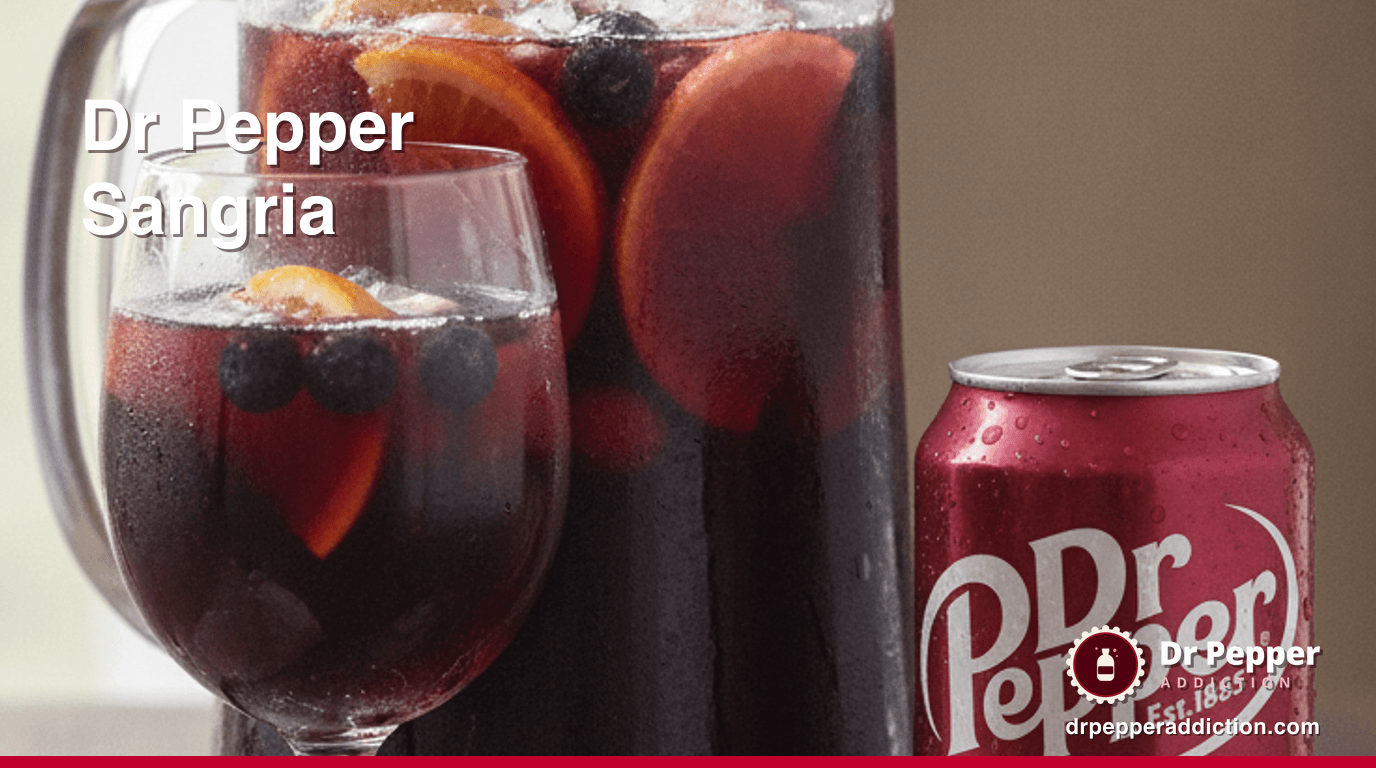 A pitcher of Dr Pepper red wine sangria with orange, apple and berries, a can of Dr Pepper beside it
